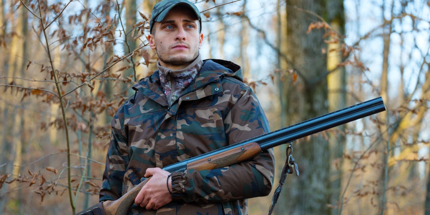 man deer hunting with shotgun